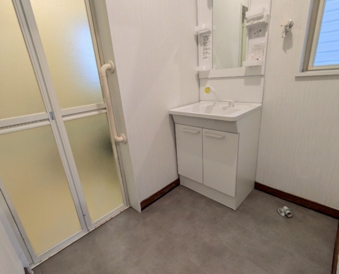 東京都江東区東雲のマンションで洗面化粧台交換と洗面室内装リフォーム後の洗面脱衣室全体（施工後）